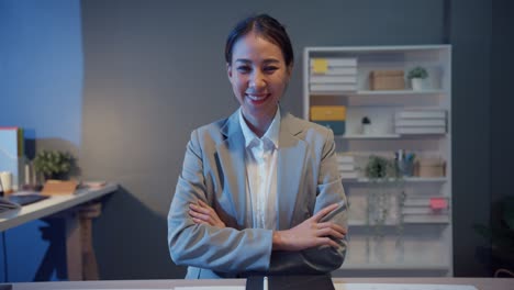 portrait of executive businesswoman smart casual wear looking at camera and smiling, happy in modern office workplace night. young asia lady talk to colleague in video call meeting at home.