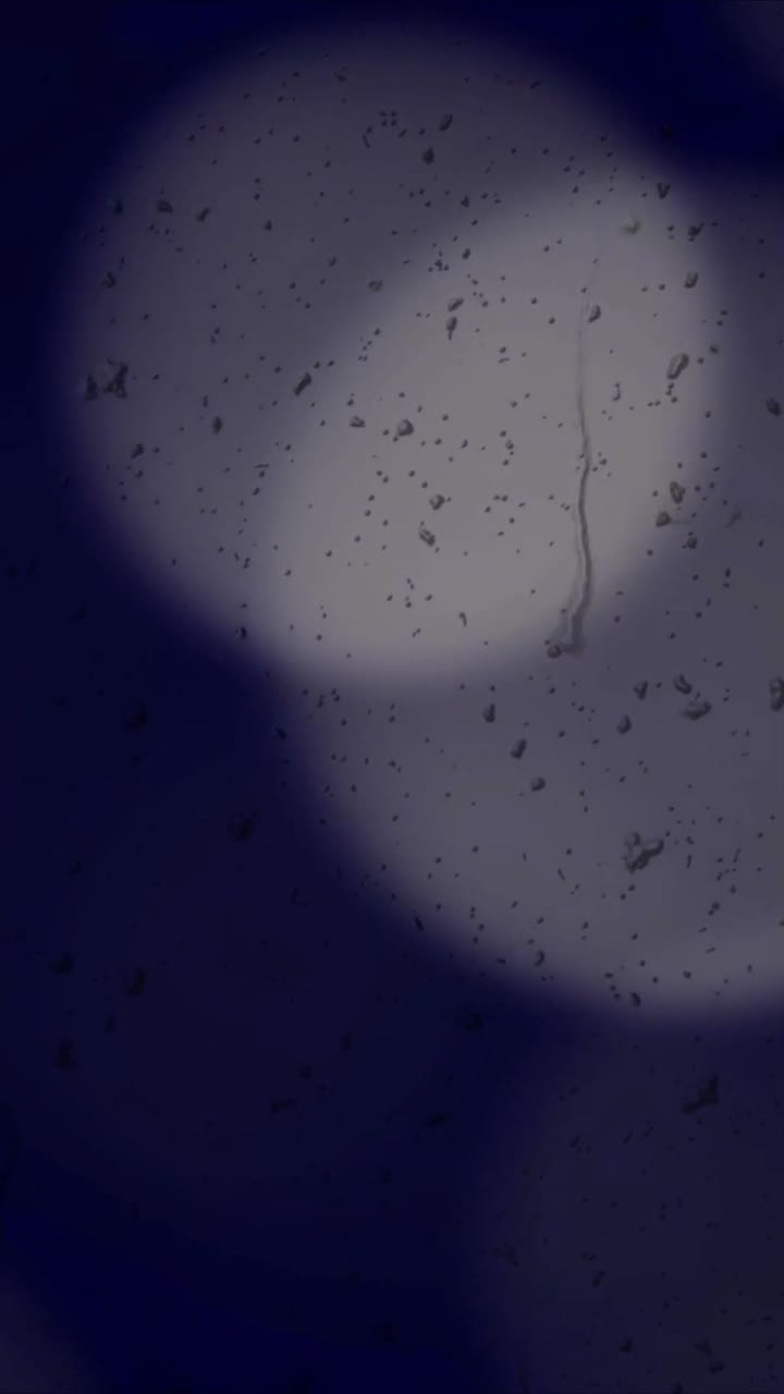 Rainy Window with Abstract Bokeh Lights at Night