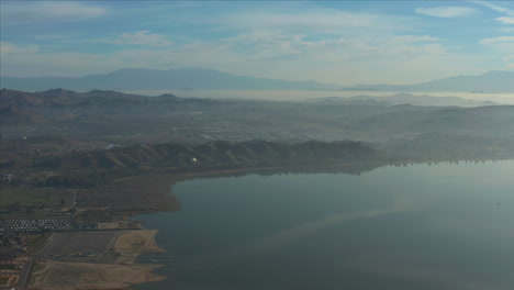 aerial drone shot of the mist covered lake elsinore, california, usa