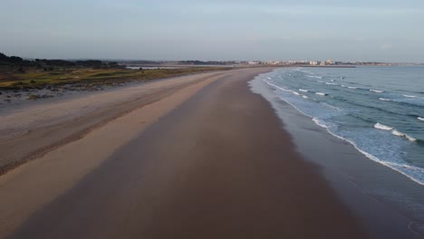 Aerial-shoot-by-drone,-flying-over-a-beach-at-Algarve,-Portugal