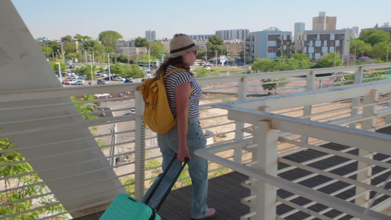 Woman in Summer Hat Walking Through Airport Walkway