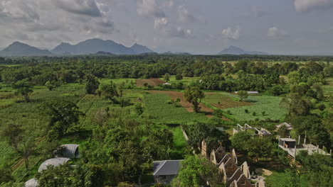 sigiriya sri lanka aerial v3 low drone flyover secluded resort hotels surrounded by lush green environment and agricultural farmlands and mountain landscape - shot with mavic 3 cine - april 2023