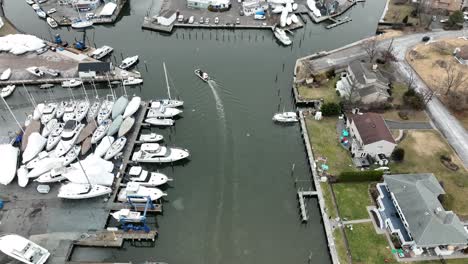 An-aerial,-high-angle-view-over-an-icy-inlet-in-Bay-Shore,-NY-on-a-cloudy-and-cold-morning