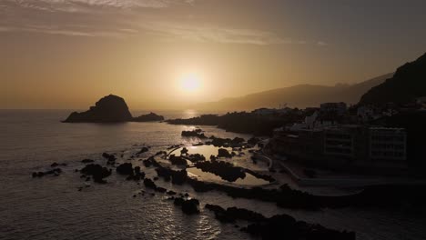 skyline and relaxing warm sunset over scenic madeira, porto moniz coastal, drone panoramic