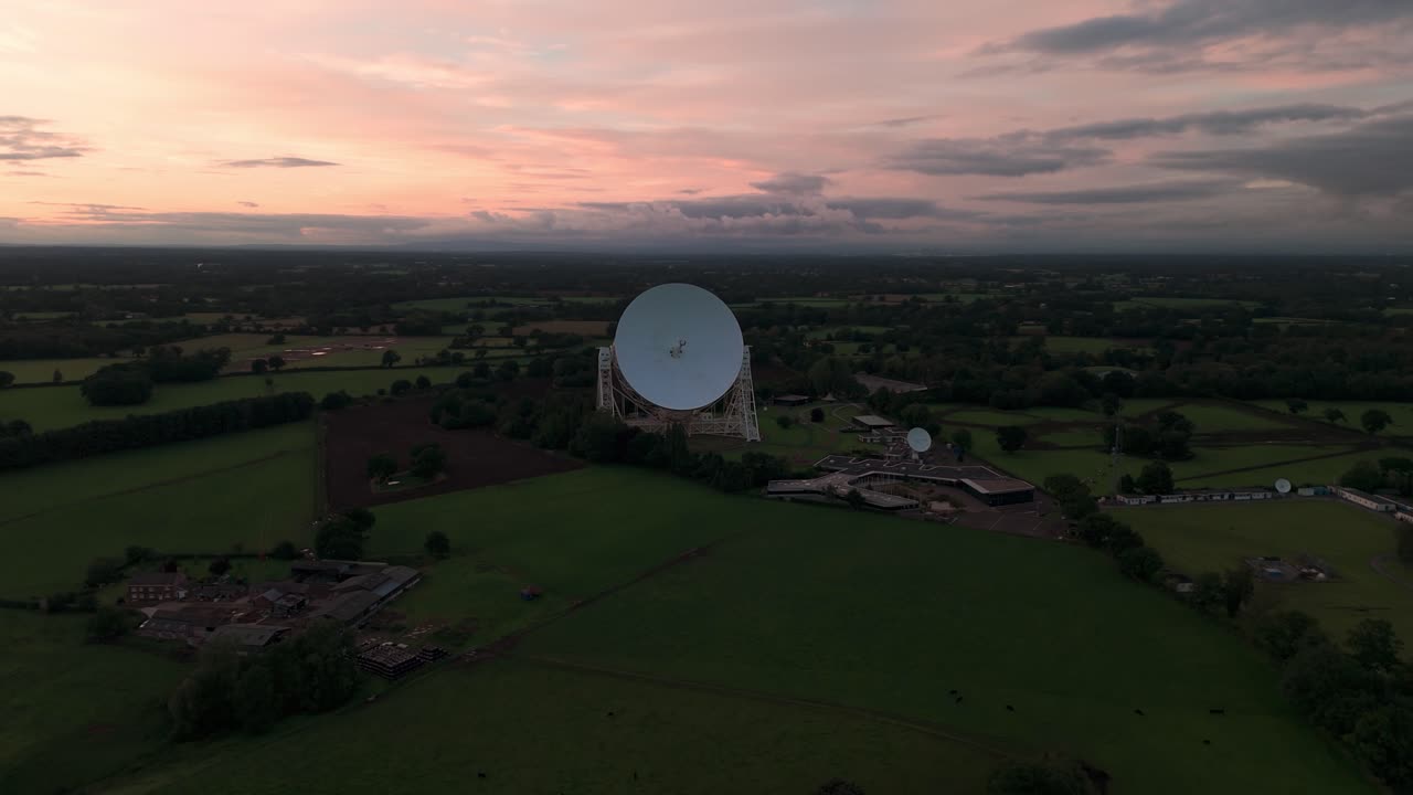 The lovell telescope at jodrell bank observatory surrounded by fields, aerial view