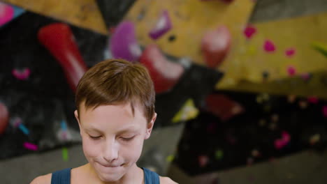 teenage boy drinking water in an indoor gym