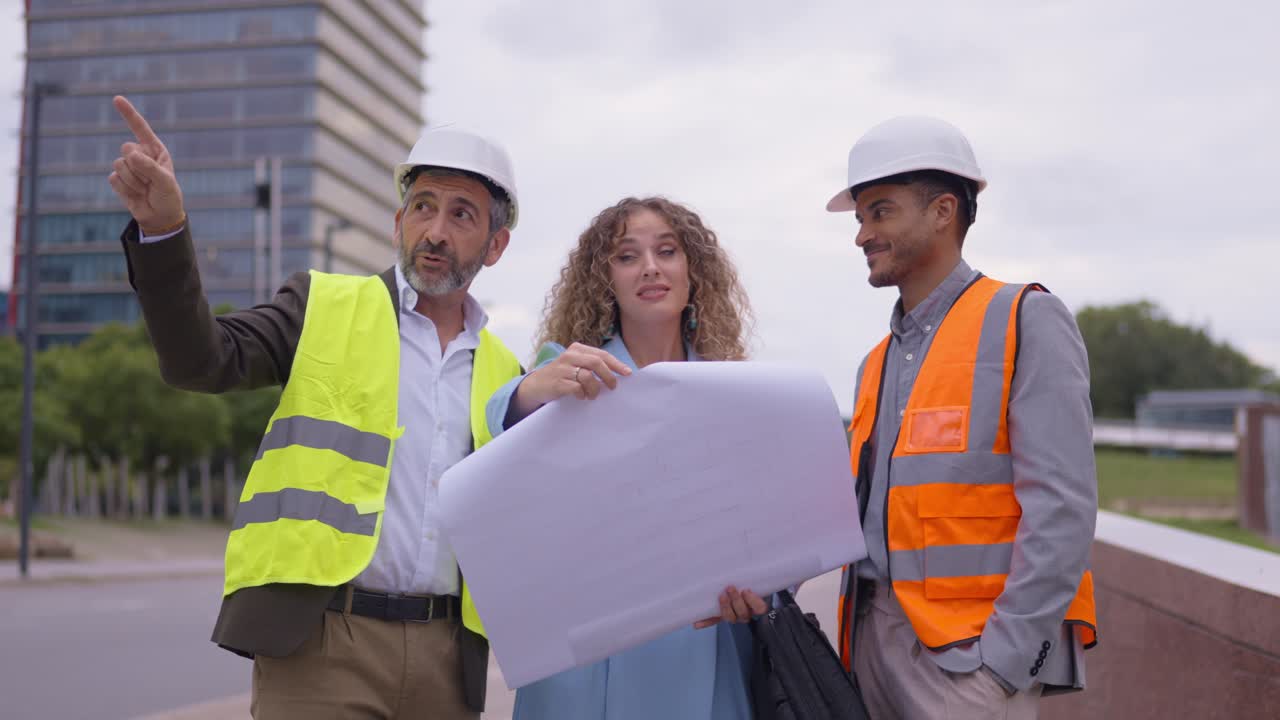 Construction Workers and Architect Discussing Plans on a Building Site