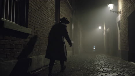 man walking in a foggy alley at night