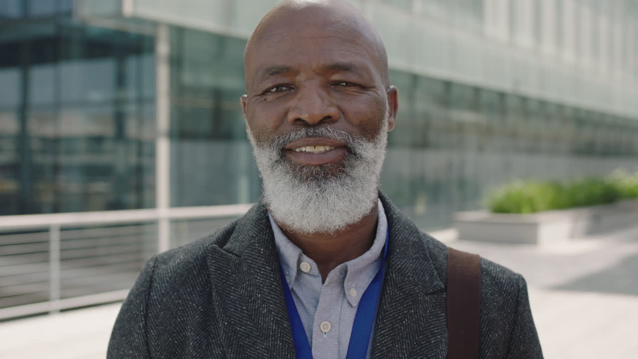 close up portrait of senior african american businessman ceo smiling confident in urban city