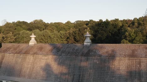 Beautiful-old-historic-barn-and-silos-in-low-angle-drone-flying-view