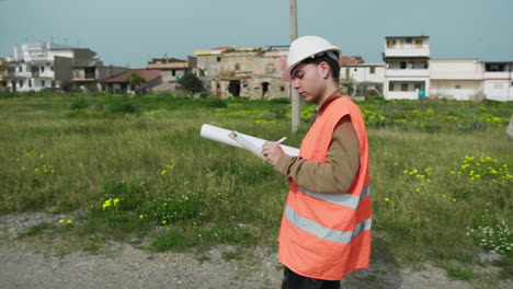 building engineer writing notes while working outdoor