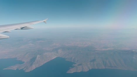 view of the wing of a plane from inside whilst flying