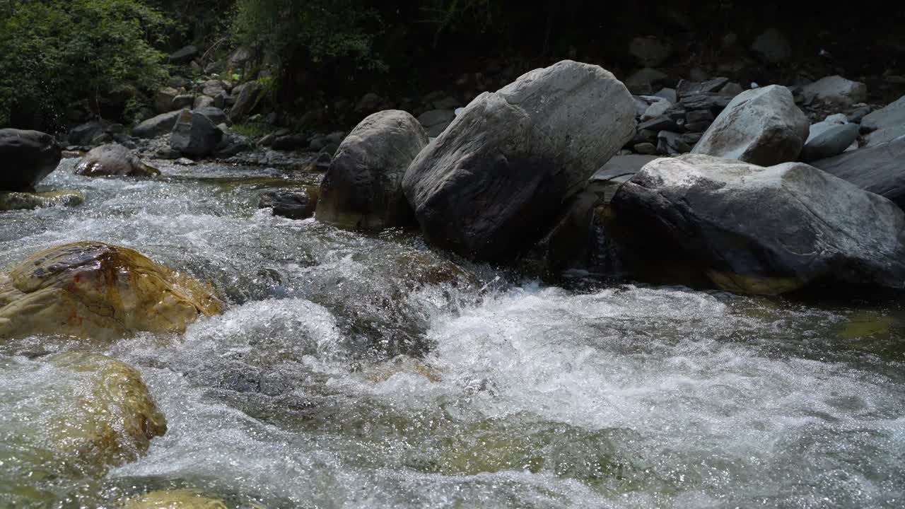 Water is flowing through a mountain torrential river.
