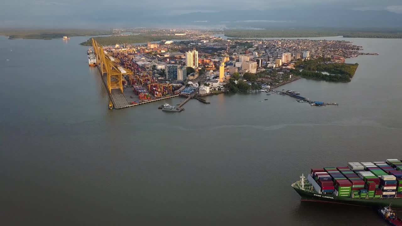 Aerial of big merchant ship arriving at the port in Buenaventura