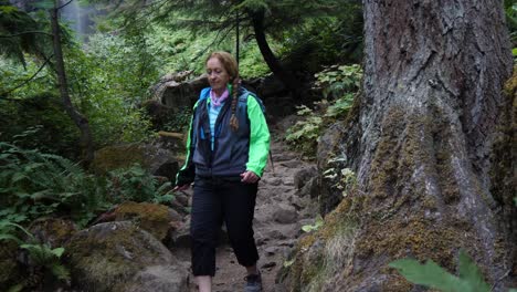 senior backpacker makes her way down a steep rocky trail