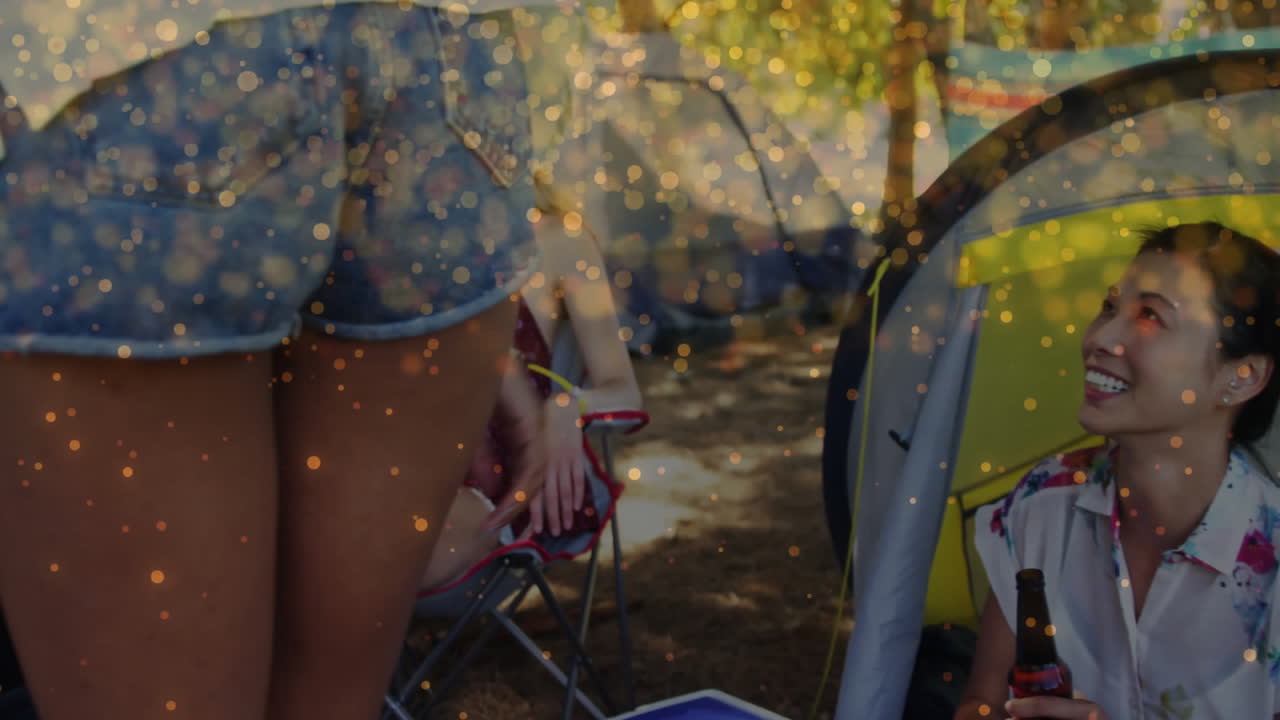 business team gathering at yellow tent camp, showing chart overlays above blue cooler