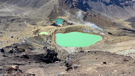 green sulphur pools on the top of a mountain range in new zealand