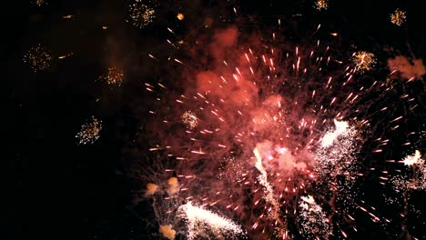 fireworks flashing in the night sky. slow motion. real fireworks with smoke