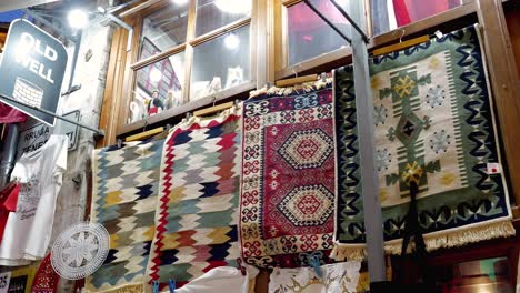 A-souvenir-stand-in-the-Albanian-city-of-Gjirokastër,-featuring-exquisite-handmade-carpets
