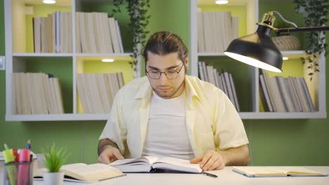 Focused-serious-young-man-studying,-doing-research.