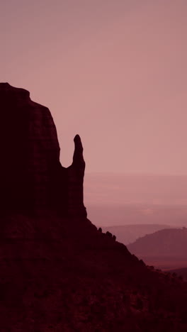 silhouette of a rock formation against a red sunset