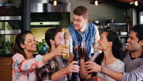 Friends-toasting-drinks-together-in-restaurant