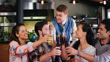 friends toasting drinks together in restaurant