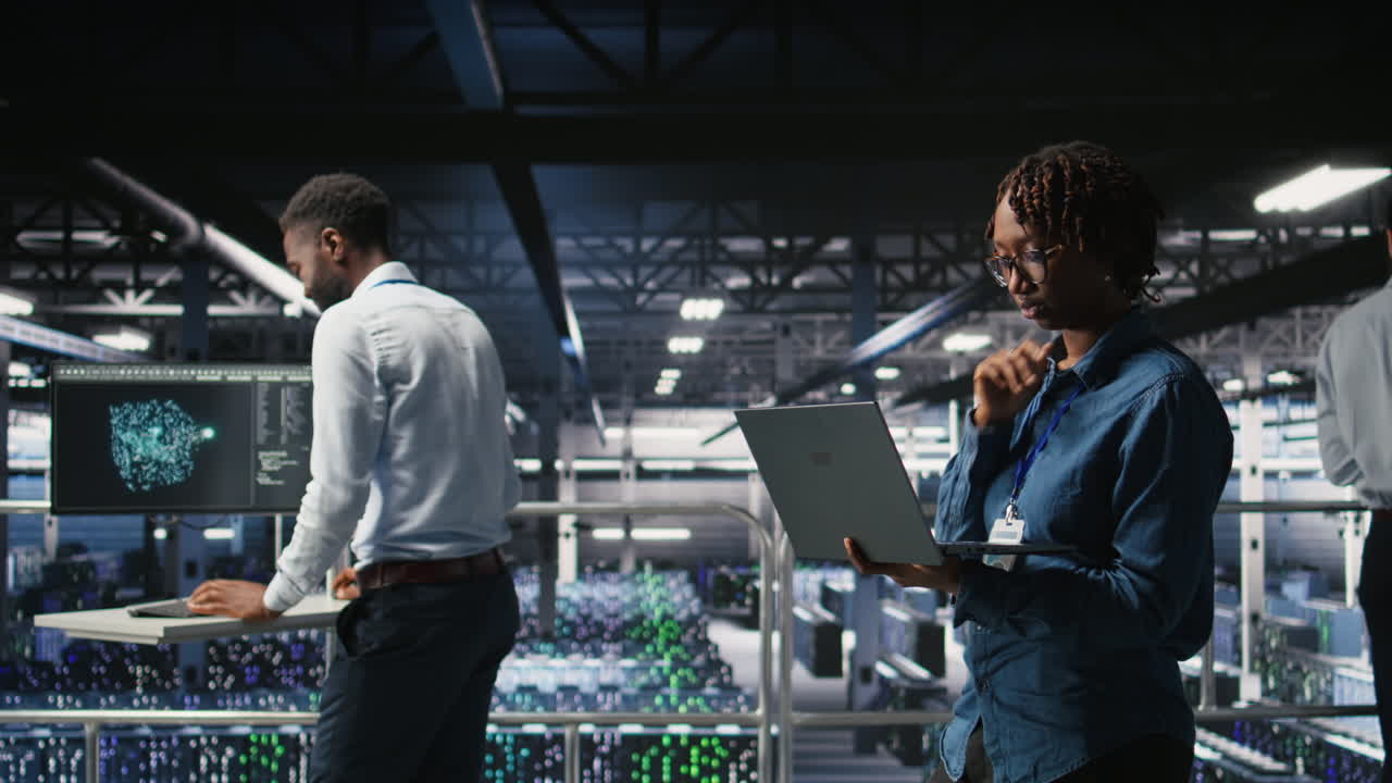 System administrators on data center platform analyzing performance outputs