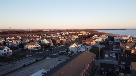 a beautiful aerial drone shot, flying over beachfront houses in the suburbs of cape may new jersey, cape may county