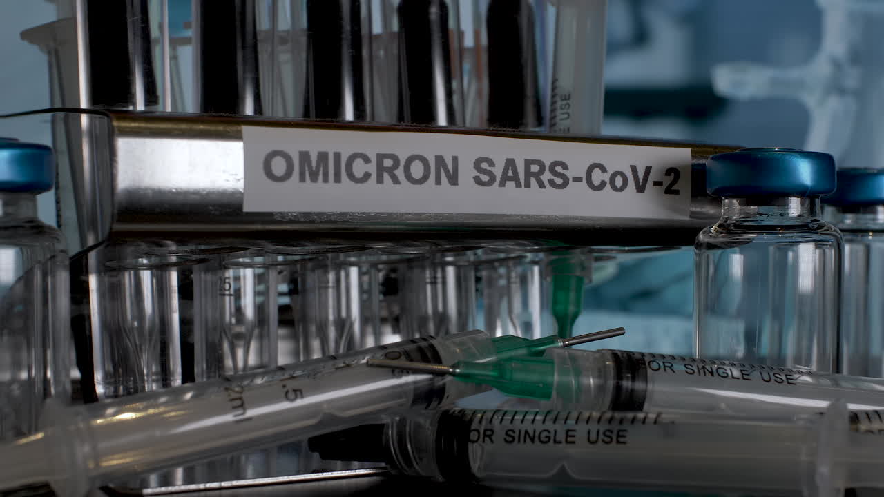 Close up dolly shot tracking back revealing a rack of medical equipment labelled Omicron SARS-CoV-2 as test tubes samples are removed, the latest strain of Covid 19 found in South Africa