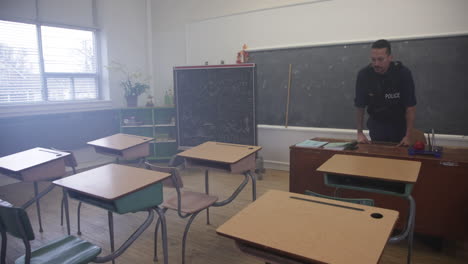 Police-officer-at-the-front-of-an-empty-classroom