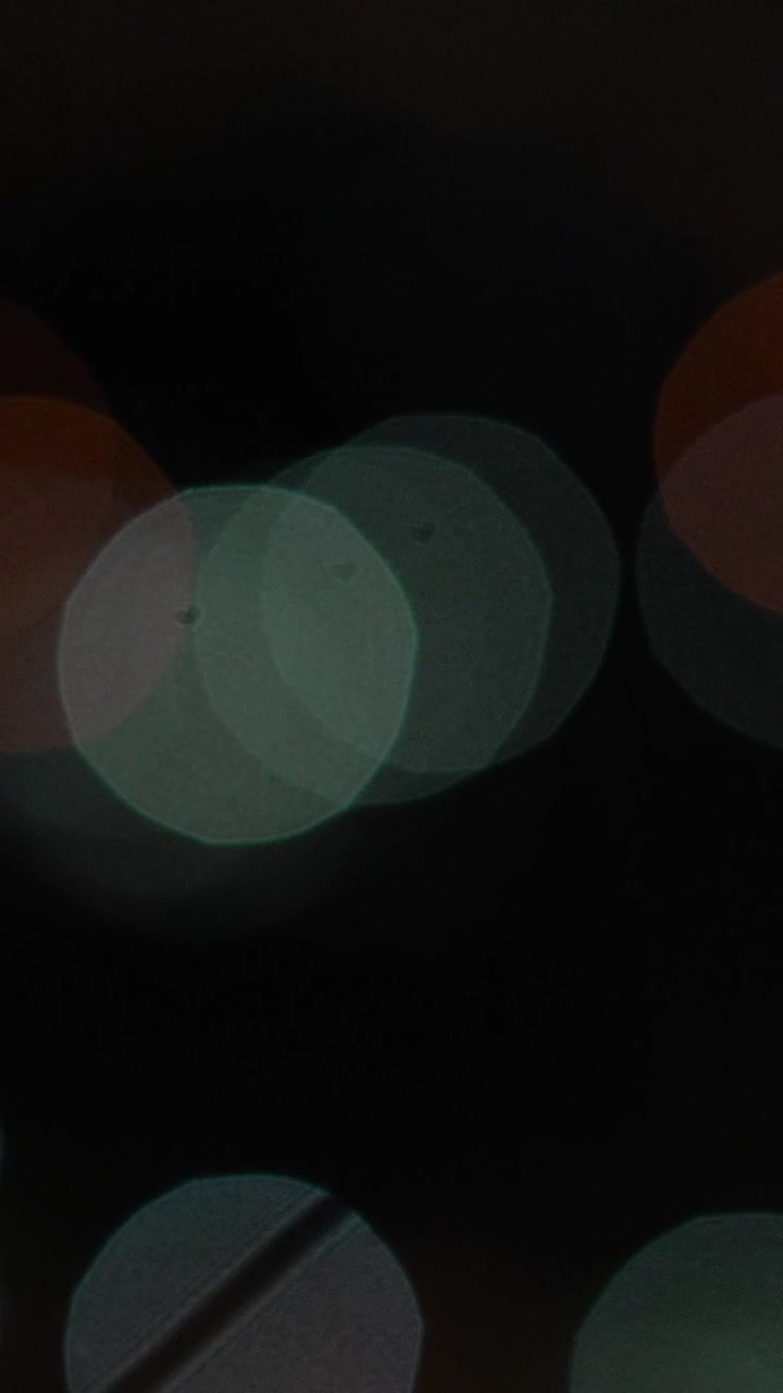 A blurred image of the colorful city lights at night. Bokeh Defocus Background.