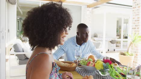 video of african american family spending time together and having dinner outside