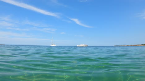 a boat and a yacht in green water