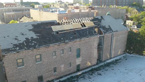 Drone-forward-moving-shot-over-an-abandoned-burnt-house-roof-at-daytime