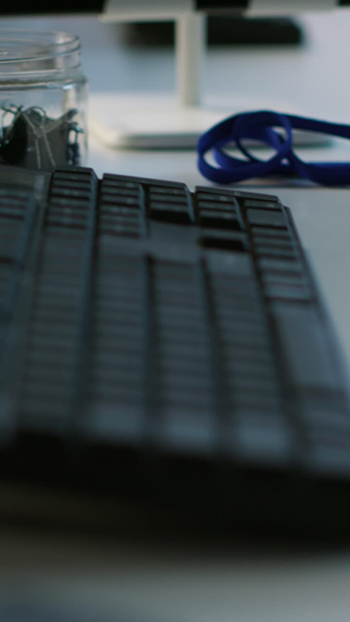 Vertical video Close up of computer peripherals on server room desk