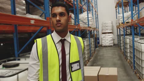 Young-man-working-in-warehouse-moving-boxes-4k