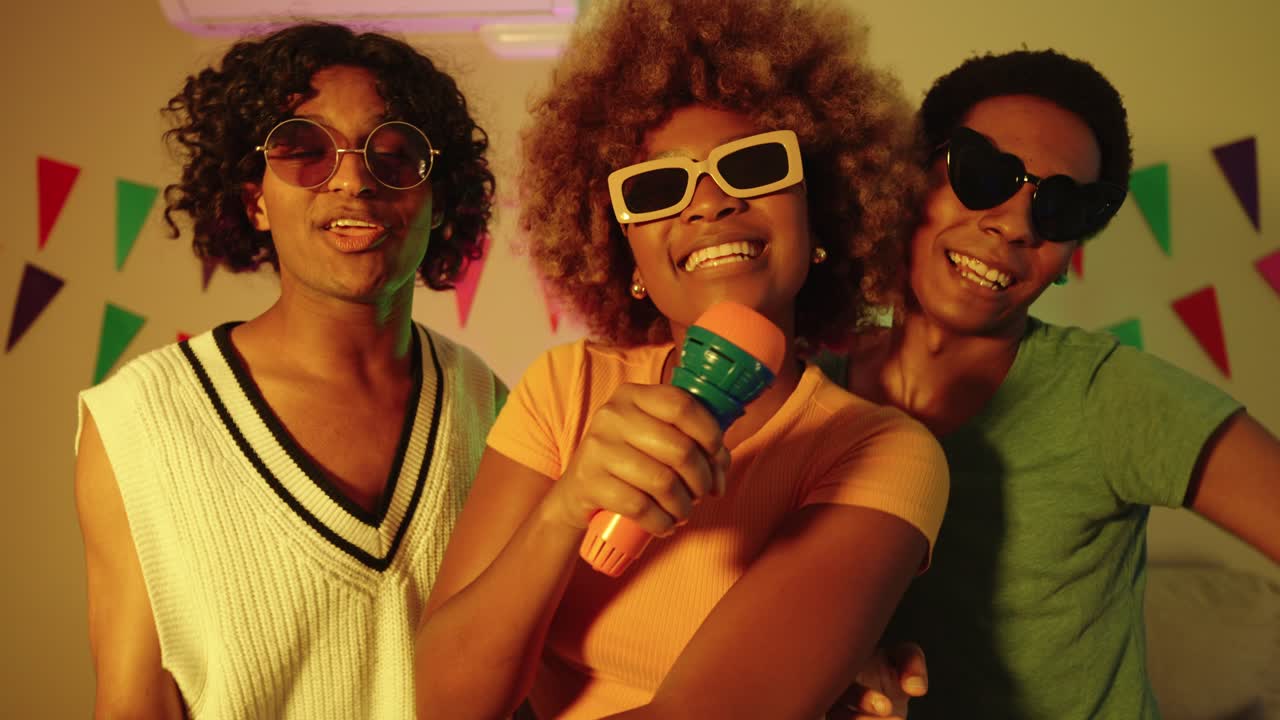 Group of friends having karaoke party