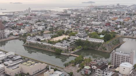imabari castle and city, aerial tilt reveals japan inland sea
