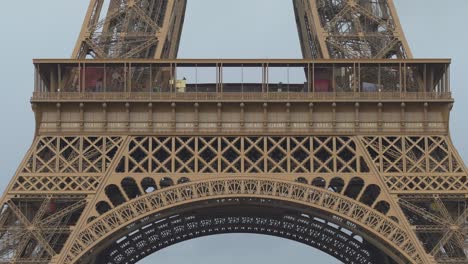 first floor of eiffel tower on a gloomy day in paris