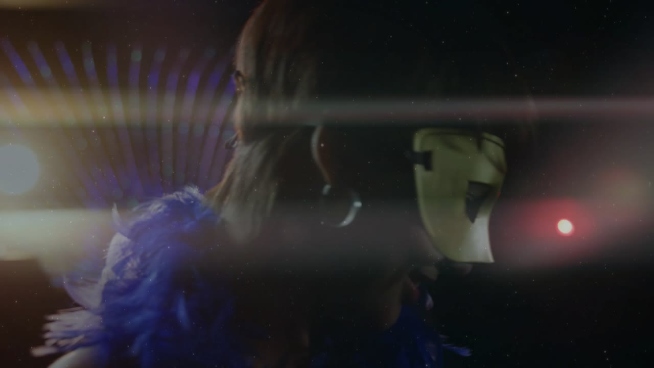 Performer prompted by light streaks, turning head and lifting arm through lens flares to captivate