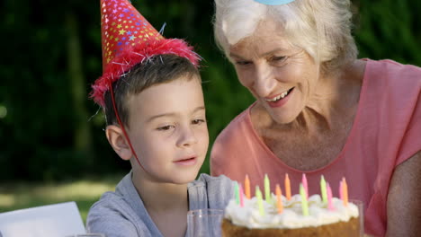 a little boy looking his birthday cake