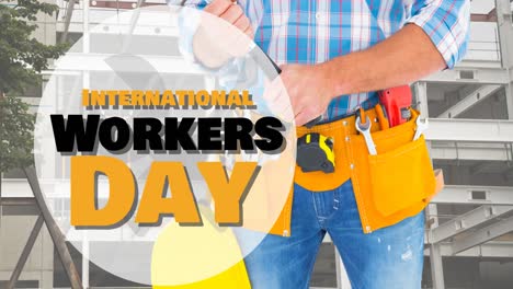 Animation-of-international-workers-day-text-over-caucasian-male-worker-with-hammer