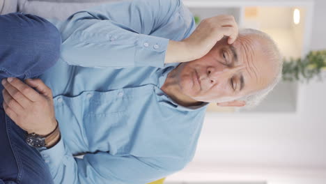 Vertical-video-of-Old-man-looking-thoughtfully-at-camera.