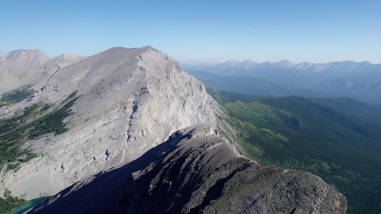 Aerial Fly Towards Carnarvon Lake along Jagged Cliff, Kananaskis, Alberta, Canada