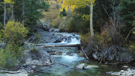 Marble-Crystal-Mill-Colorado-scenic-aerial-drone-cinematic-fall-autumn-Southern-Colorados-late-afternoon-sunset-cloudy-shaded-fallen-tree-landscape-forward-movement-up-the-river