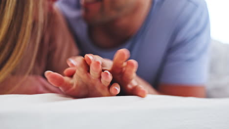 Love,-closeup-and-couple-holding-hands-in-bed