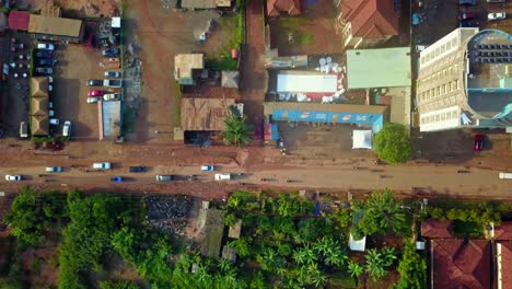 vehicles driving on the road by the market in kampala, uganda