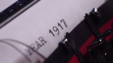 year 1917, typing on white paper in vintage typewriter, macro close up