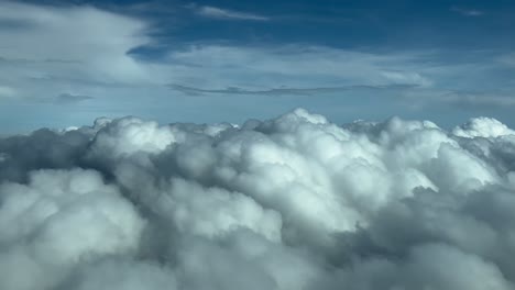 stunning aerial view of fluffy white cumulus clouds and blue sky